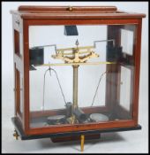 A pair of early 20th century Oertling Ltd ( London ) scientific apothecary scales set within glass