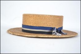 An early 20th century good quality vintage straw boater being signed to the inside with illegible