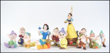 A collection of several Disney figures. Snow White and the Eleven dwarfs some doubles.