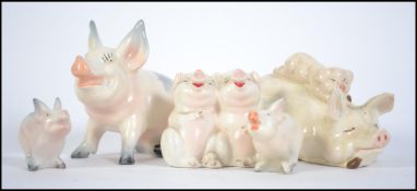 A collection of five ceramic Beswick Pigs to include Piggy back pig and piglet 2746, Pig 832,
