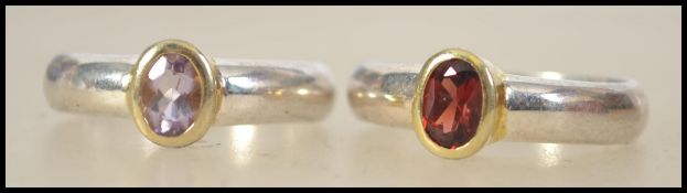 Two ladies silver rings, one being set with an amethyst oval cut stone,