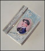 A silver tested vesta vignette case in the form of a book with pictorial top of a horse jockey.