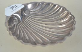 A silver hallmarked bon bon dish in the form of a scallop shell raised on three ball feet.