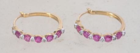 A pair of 9ct gold diamond and ruby hoop earrings. Weight 2.