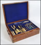 A good quality early to mid 20th century oak cased canteen of cutlery.