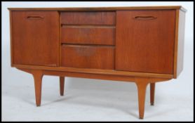 A 1970's retro Jentique teak wood sideboard of small proportions being raised on tapered legs with
