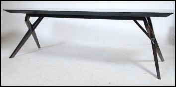A 20th century modernist coffee table with polished mirror metal reactangular top over x-frame base