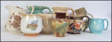 A collection of vintage 20th century water jugs by various makers to include Royal Doulton,