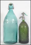 A large vintage 20th century French glass bottle reading Aguas De Lanjaron to the front together