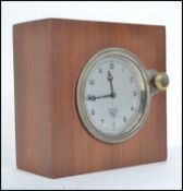A vintage 1940's Smiths car clock set within a walnut block.