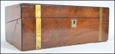 A 19th century brass banded mahogany writing slope box opening to reveal a fully appointed
