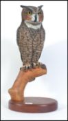 A large and impressive hand carved and crafted black forest inspired study of a short eared owl