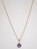 A 9ct gold amethyst and diamond pendant necklace and chain. Weight 4.