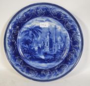A 19th century large flo blue charger, the wide rim being decorated in high relief,