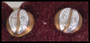 A pair of hallmarked 14ct white,yellow gold and diamond earrings. Total weight 2g.