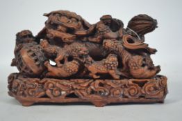 A 20th century Chinese temple dog figurine raised on a socle plinth base