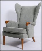 A good quality 20th century Parker Knoll wingback armchair raised on cabriole legs with pad feet,