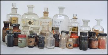A large collection of vintage 20th century apothecary bottles many with original lables to the