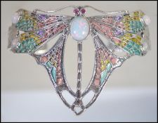 A ladies silver plique a jour Art Deco style bangle inset with opal stones.
