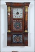 A Victorian large wall mounted Jerome & Co ginger bread clock with gilded columns with glass