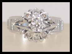 A hallmarked 1970's 18ct white gold and diamond ladies dress ring of naturalistic form with bark