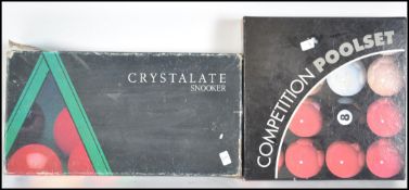 A boxed set of 20th century crystallite snooker balls together with a boxed set of Competition pool