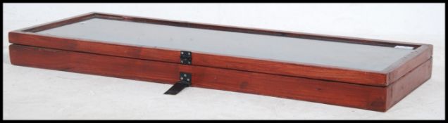 A vintage 20th century mahogany counter top display cabinet having a glazed hinged top.