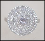 A pretty ladies contemporary silver and cz adorned cluster ring of roundel form. Size Q.