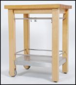 A contemporary beech wood chunky kitchen island table - preparation stand being raised on squared