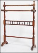 A Victorian 19th century mahogany towel rail stand being raised with turned and spiral fluted