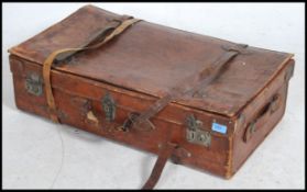 A good quality vintage tan leather suitcase retaining all the original leather straps.
