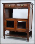 An Edwardian mahogany side cabinet having bevelled plate glass door over open shelf beneath.