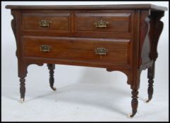 An Edwardian mahogany 2 over 2 chest of drawers being raised on turned legs with flared top above