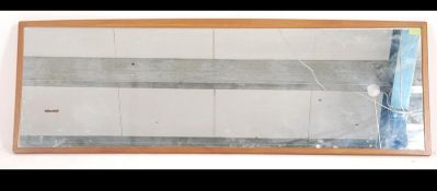 A large 20th century teak backed mirror having bowed detail to top.