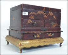 A vintage early 20th century Japanese chinoserie laquered jewellery box with hinged cover,