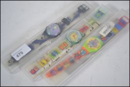 A collection of 3 vintage Swatch watches, all in original packaging.