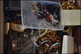A collection of vintage and contemporary costume jewellery to include beaded necklaces, bangles,