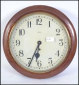 An early 20th century station clock by Enfield set within a circular mahogany case with glass facia