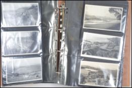 A good collection of vintage 20th century postcards in an album dating back to the Edwardian era