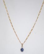 A ladies 14ct diamond and sapphire pendant necklace chain.
