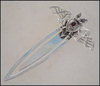 A contemporary silver bookmark of pierced tapering form adorned with a bat motif to the top set