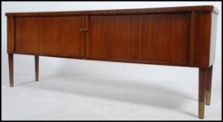 A 1970's Danish influence teak wood tambour front sideboard.