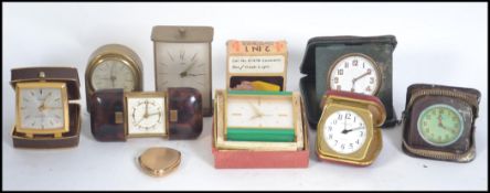 A collection of vintage 20th century travel / alarm clocks to include an Art Deco cased Goliath