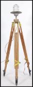 A stunning vintage upcycled wooden surveyors tripod base having a later fitted industrial bulkhead