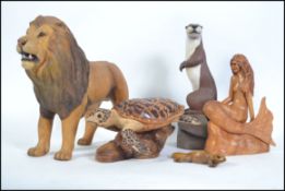 A collection of 4 impressive hand carved and crafted animal wooden figurines to include a large