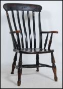 A Victorian beech and elm Windsor chair raised on turned legs with stretchers having saddle seat