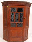 A Victorian oak Arts & Crafts corner cupboard in the manner of Shapland & Petter.