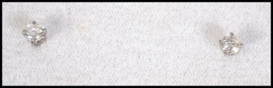 A pair of 9ct white gold and diamond stud earrings. Diamonds approx total 50pts / 1/2 carat.