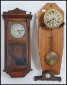 A 20th century oak cased wall clock with an eight day movement together with a wall mounted