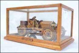 An impressive hand carved and crafted cased wooden model of the 1903 Mercedes being fully